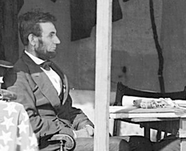 This image depicts Abraham Lincoln sitting and pondering with George McLellan.